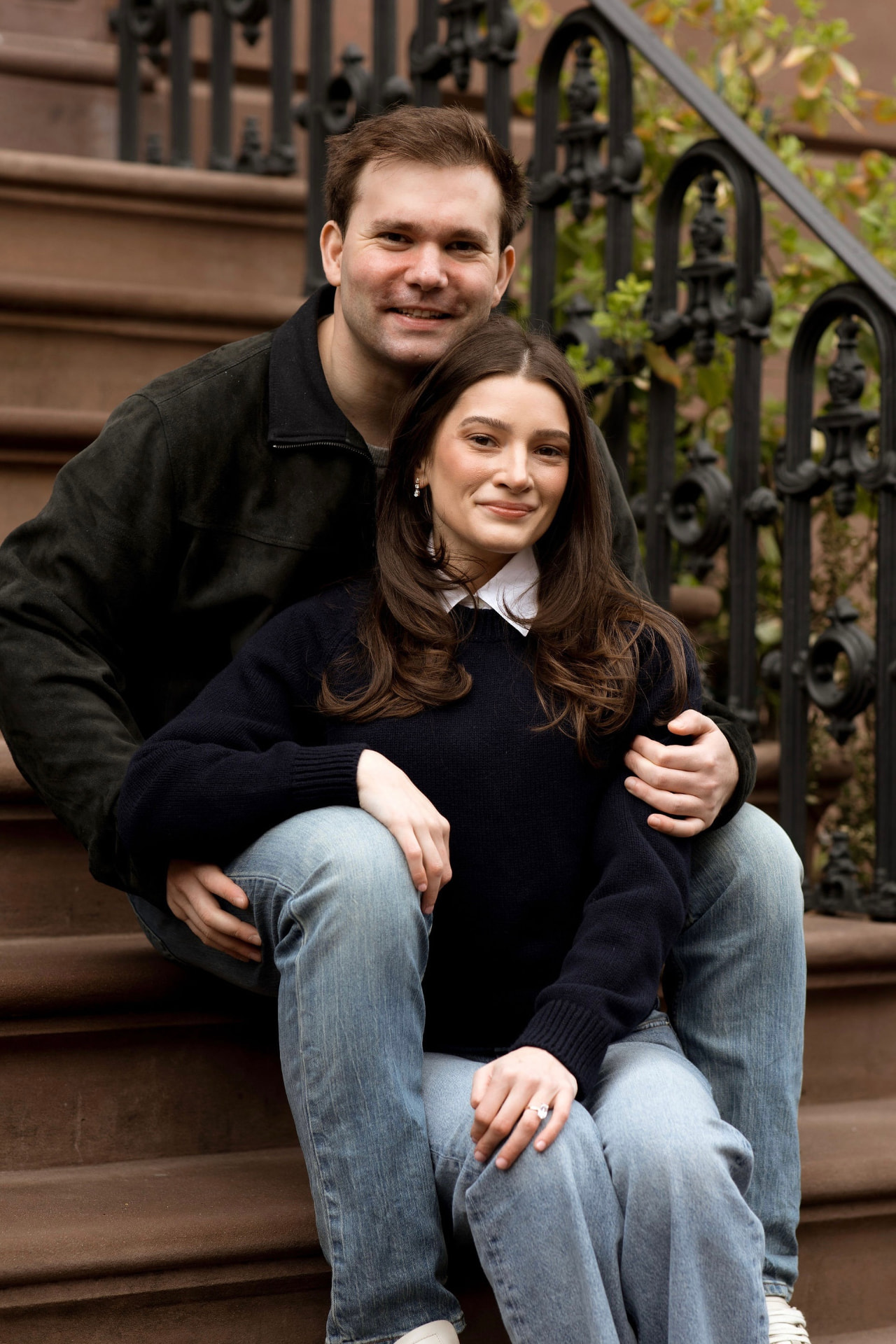 Allie and Sean sitting together on a New York City brownstone stoop